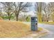 Modern dark gray brick mailbox with house number, gravel driveway, and trees in the background at 2745 Bonnybrook Cir, Rock Hill, SC 29732