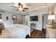 Cozy main bedroom with ceiling fan, wood floors, barn door to ensuite, and ample natural light at 2745 Bonnybrook Cir, Rock Hill, SC 29732