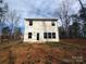 Rear exterior view of a house with a backyard and surrounded by lush trees, offering privacy at 2792 5Th Ne Ave, Hickory, NC 28601