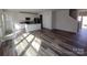 Open floor plan with luxury vinyl plank flooring connecting living, kitchen, and dining areas at 2792 5Th Ne Ave, Hickory, NC 28601
