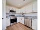 New kitchen features white cabinets, granite countertops, and stainless steel appliances at 2890 South River Church Rd, Woodleaf, NC 27054