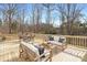 A large wooden deck with outdoor seating perfect for enjoying nature at 301 Dollar Cir, Charlotte, NC 28270
