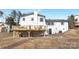 A shot of the back of the house with a large wooden deck and lots of supports underneath at 301 Dollar Cir, Charlotte, NC 28270