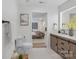 A well-lit bathroom featuring wood cabinetry, a modern sink, and a view of the bedroom at 301 Dollar Cir, Charlotte, NC 28270