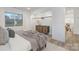 Cozy bedroom showcasing a walk-in closet and ample light from a large window at 301 Dollar Cir, Charlotte, NC 28270