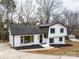 Charming two-story home with white brick, black trim, and a welcoming front entrance at 301 Dollar Cir, Charlotte, NC 28270