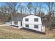 Charming two-story home with white brick and a spacious yard and long driveway at 301 Dollar Cir, Charlotte, NC 28270