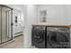 Bright laundry room featuring modern washer and dryer, and stylish sink vanity with updated fixtures at 301 Dollar Cir, Charlotte, NC 28270