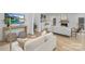 Open-concept living room with comfortable seating, modern lighting, and a TV mounted above a table at 301 Dollar Cir, Charlotte, NC 28270