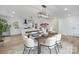An open concept living space with modern décor, including a kitchen, dining area, and staircase at 301 Dollar Cir, Charlotte, NC 28270