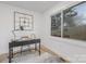 Home office featuring sleek desk, stylish decor, and bright natural light from a large window at 301 Dollar Cir, Charlotte, NC 28270