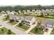 An aerial view showcases a neighborhood with mature trees, well-manicured lawns, and varied home styles at 3173 Delaware Dr, Denver, NC 28037