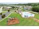 Aerial view of community amenities including a pool, playground, clubhouse, and parking area at 3173 Delaware Dr, Denver, NC 28037
