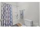 Clean bathroom with a shower-tub combo, toilet, towel bar, and modern shower curtain at 3173 Delaware Dr, Denver, NC 28037