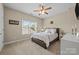 Cozy bedroom with a queen-size bed, a ceiling fan, and a bright window providing natural light at 3173 Delaware Dr, Denver, NC 28037