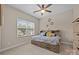 Cozy bedroom featuring a bed with built-in storage, ceiling fan, and a bright window at 3173 Delaware Dr, Denver, NC 28037