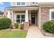 Inviting front porch featuring stone accents, potted plants, seating, and American flag at 3173 Delaware Dr, Denver, NC 28037
