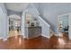 Hallway featuring hardwood floors, and an adjacent stairway to the upper level at 3173 Delaware Dr, Denver, NC 28037