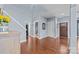Open hallway featuring stairs, multiple rooms, and hardwood flooring at 3173 Delaware Dr, Denver, NC 28037