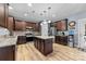 Stylish kitchen featuring dark wood cabinets, an island, and modern appliances at 3173 Delaware Dr, Denver, NC 28037