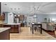 Open kitchen featuring dark wood cabinets, stainless steel appliances, and eat-in dining at 3173 Delaware Dr, Denver, NC 28037