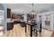 Open kitchen featuring dark wood cabinets, an island, and eat-in dining area at 3173 Delaware Dr, Denver, NC 28037