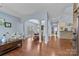 Open-concept living area with hardwood floors, archways, and a view into the adjacent dining room and kitchen at 3173 Delaware Dr, Denver, NC 28037