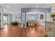 Spacious living area with hardwood floors, archways, and an open layout with a view into the adjacent dining room at 3173 Delaware Dr, Denver, NC 28037