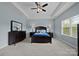 Comfortable main bedroom featuring a tray ceiling, neutral walls, and a well-appointed furniture set at 3173 Delaware Dr, Denver, NC 28037