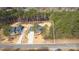 Aerial view of a home on a large lot, surrounded by lush trees, a long driveway, and a two car garage at 318 Lewis Ferry Rd, Statesville, NC 28677