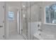Luxurious bathroom with a glass shower, soaking tub, and elegant tile work at 318 Lewis Ferry Rd, Statesville, NC 28677