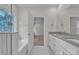 Bright bathroom featuring double sinks, granite countertops, and a separate tub at 318 Lewis Ferry Rd, Statesville, NC 28677