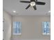 This bright bedroom has a ceiling fan and two large windows for optimal natural light at 318 Lewis Ferry Rd, Statesville, NC 28677