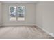 Bright, neutral bedroom with carpet, neutral walls and natural light from the windows at 318 Lewis Ferry Rd, Statesville, NC 28677