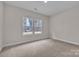 Bright bedroom with carpet, neutral walls, and natural light from the two windows at 318 Lewis Ferry Rd, Statesville, NC 28677