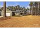 Charming craftsman style home boasts a two-car garage and a sprawling front lawn with mature trees at 318 Lewis Ferry Rd, Statesville, NC 28677