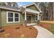 Inviting front porch with decorative brick columns and a pathway leading to the beautiful stained wood front door at 318 Lewis Ferry Rd, Statesville, NC 28677