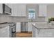 Bright kitchen featuring stainless steel appliances, granite countertops, and white cabinets with modern hardware at 318 Lewis Ferry Rd, Statesville, NC 28677