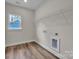 This laundry room features wood-style flooring and modern washer and dryer hookups at 318 Lewis Ferry Rd, Statesville, NC 28677