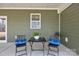 Relaxing covered patio with a seating area, perfect for outdoor enjoyment at 318 Lewis Ferry Rd, Statesville, NC 28677