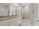 Bright bathroom featuring double vanities, a glass-enclosed shower, neutral tile, and a well-lit space at 326 Lewis Ferry Rd, Statesville, NC 28677