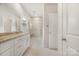Modern bathroom featuring a granite countertop vanity, a glass-enclosed shower, and neutral tile at 326 Lewis Ferry Rd, Statesville, NC 28677