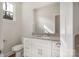 Bright bathroom featuring a granite countertop, white cabinets, and a window for natural light at 326 Lewis Ferry Rd, Statesville, NC 28677