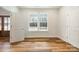 Bright bedroom featuring hardwood floors, natural light, and easy access to the entry foyer at 326 Lewis Ferry Rd, Statesville, NC 28677