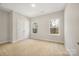 Bedroom with carpet, neutral walls, two windows, and a closet, offering bright and spacious accommodation at 326 Lewis Ferry Rd, Statesville, NC 28677