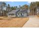 Charming single-story home boasts a welcoming porch and a long driveway leading to a two-car garage at 326 Lewis Ferry Rd, Statesville, NC 28677