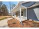 Inviting covered front porch with classic columns and a view of the landscaped yard at 326 Lewis Ferry Rd, Statesville, NC 28677