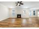 Bright living room with a cozy fireplace, ceiling fan, and beautiful wood-look floors at 326 Lewis Ferry Rd, Statesville, NC 28677
