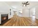 Spacious open-concept living room with a fireplace, hardwood floors, and a ceiling fan at 326 Lewis Ferry Rd, Statesville, NC 28677