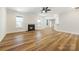 Open-concept living room with a fireplace, hardwood floors, and lots of natural light at 326 Lewis Ferry Rd, Statesville, NC 28677